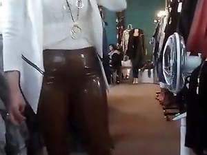 Wife in brown Latex Pants in her boutique