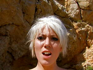 Tattooed blond beach babe with pierced nipples